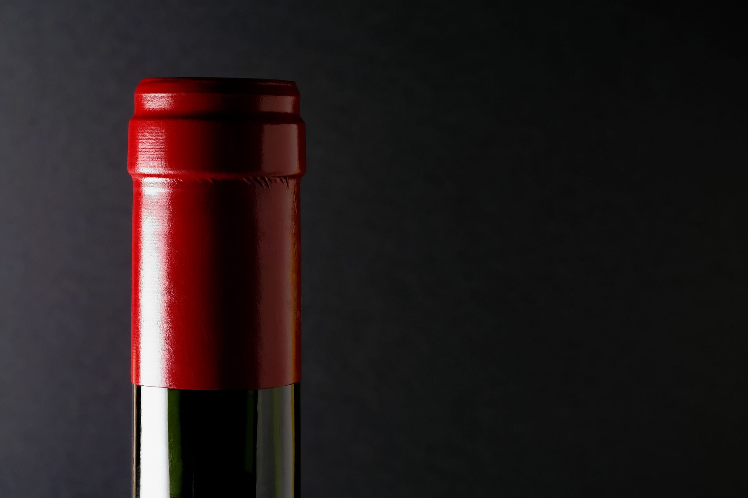 a close-up of a wine bottle that has been shrink-banded