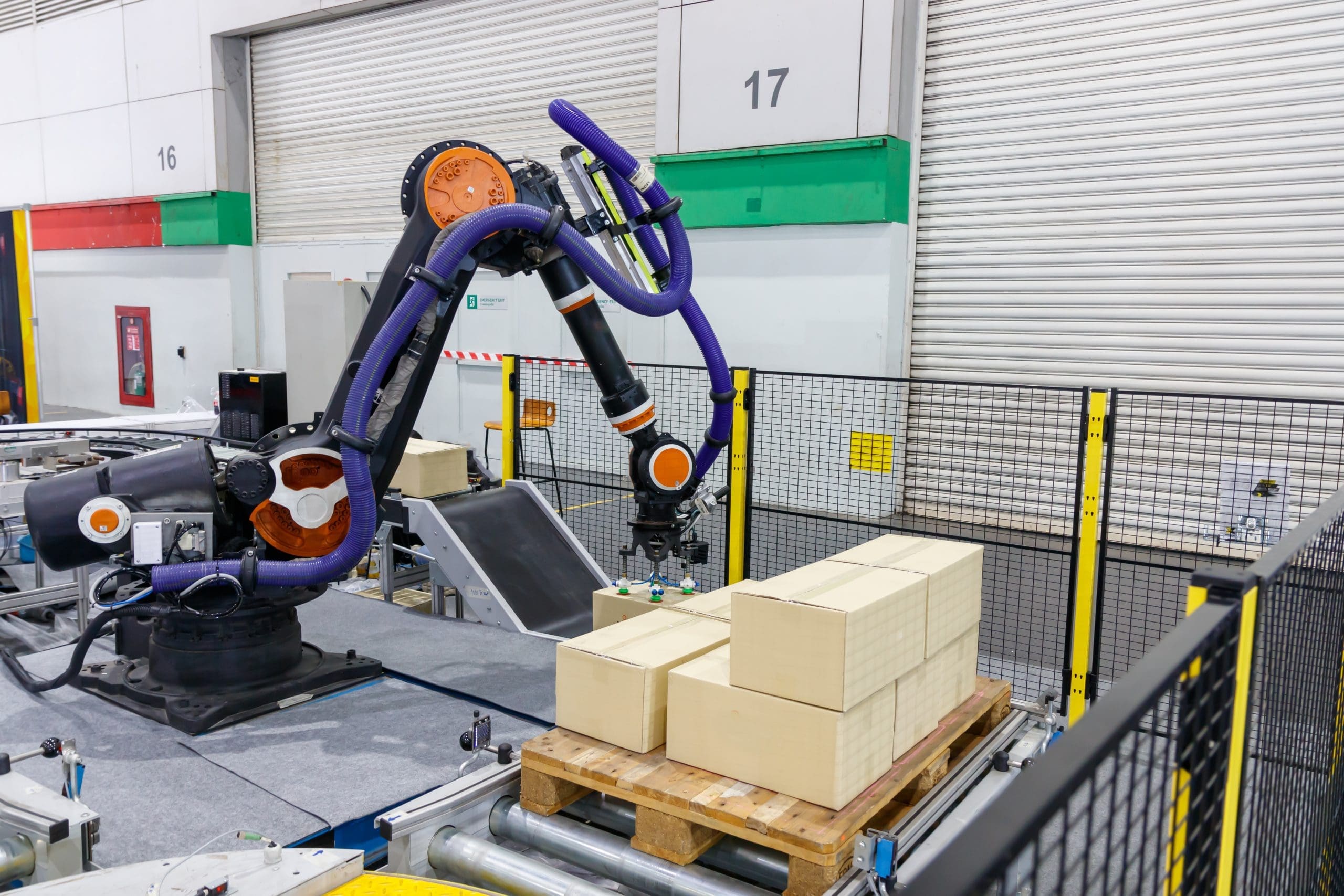 A robotic arm picking boxes