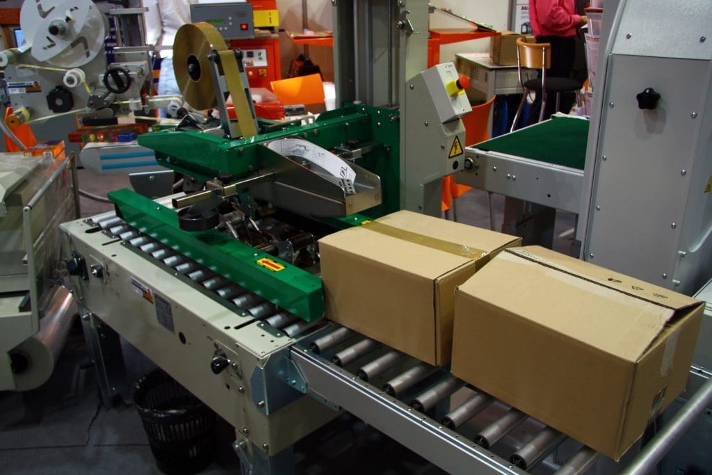 A packaging machine sealing boxes for delivery
