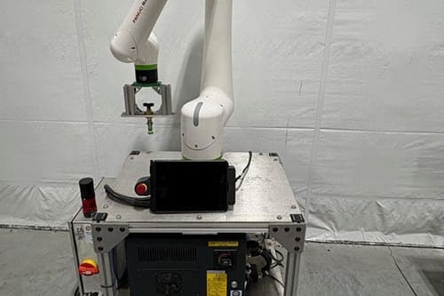 A white Fanuc robotic arm